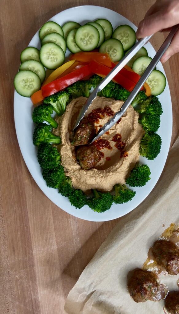 Plating Moroccan Meatballs Over Chili Crisp Hummus